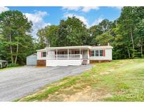 Single-wide mobile home with covered porch at 5735 High Plains Ct, Iron Station, NC 28080