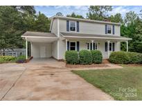 Two-story home with carport, landscaping, and driveway at 511 Colorado Trl, Lincolnton, NC 28092