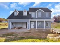 Two-story house with gray siding, attached garage, and a front porch at 4122 Old Monroe Marshville Rd, Wingate, NC 28174