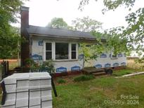 Image of a small house undergoing renovations, showing brick and new siding at 739 Kings Mountain St, Clover, SC 29710