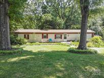 Single-wide mobile home with red roof and covered porch at 4537 Sunrise Beach Rd, Catawba, NC 28609