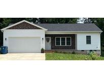 Newly constructed home with white siding, brown accents, and a two-car garage at 4050 Fairview Ln, Maiden, NC 28650