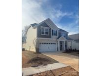 Two-story house with gray and beige siding, a two-car garage, and a partially landscaped yard at 1051 Bull Dog Ln, Wingate, NC 28174