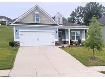 Two-story house with light blue siding, a white garage door, and landscaping at 343 Ox Bow Cir, Mount Holly, NC 28120
