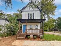 Charming two-story home with front porch and landscaping at 103 Pleasant Hill St, Lancaster, SC 29720