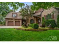 Brick home with three-car garage and landscaped front yard at 5523 Closeburn Rd, Charlotte, NC 28210