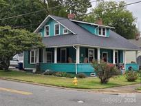 Charming teal house with a wraparound porch at 240 Bost St, Statesville, NC 28677