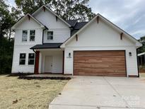 Two-story modern farmhouse exterior with wood garage door at 3739 Innes Ln, Maiden, NC 28650