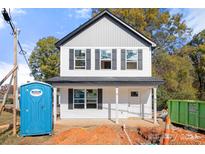 Two-story house with gray and white siding, and a front porch at 9251 Misenheimer Rd, Charlotte, NC 28215