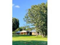 Ranch-style home with a large yard and mature trees at 1610 Sierra Rd, York, SC 29745