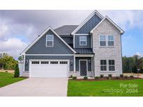 Two-story home with gray siding and stone accents at 3065 Swallowtail Ln, Kannapolis, NC 28083