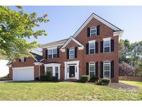 Two-story brick house with a large front yard and attached garage at 1245 Blackstone Ct, Concord, NC 28027