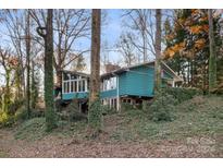 Ranch home with teal siding nestled on a wooded lot at 702 Forest Hill Dr, Shelby, NC 28150