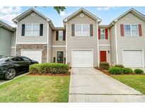 Tan-colored townhome with two-car garage and landscaping at 9345 Hamel St, Charlotte, NC 28215