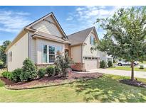 Two-story home with stone accents and landscaping at 14008 Little Spring Ct # 391, Charlotte, NC 28278