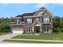 Two-story brick house with stone accents and a three-car garage at 207 Coronado Ave # 56, Matthews, NC 28104