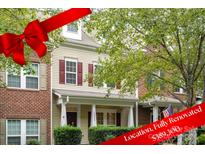 Brick front exterior of charming townhome with covered porch at 13832 Cypress Woods Dr, Huntersville, NC 28078