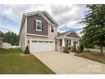 Two-story home with a large driveway at 14217 Ridgewater Way, Charlotte, NC 28278