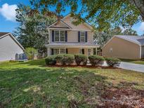 Two-story home with light beige siding and well-maintained landscaping at 325 Pelling Dr, York, SC 29745