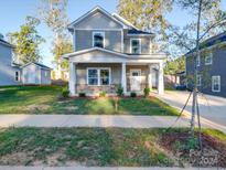Two-story gray house with a stone facade and covered porch at 558 Geneva Cir, Gastonia, NC 28056