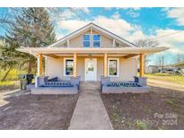 Beige house with a front porch and landscaping at 185 17Th Se St, Hickory, NC 28602