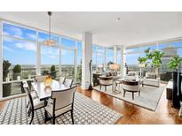 High-rise living room with city views and hardwood floors at 215 N Pine St # 3705, Charlotte, NC 28202