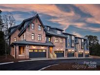Brick townhouses with gray garage doors at 3109 Colyer Pl, Charlotte, NC 28205