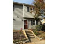 Two-story townhome with a red door and small front steps at 6116 Heath Ridge Ct, Charlotte, NC 28210