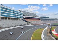 Aerial view of two cars speeding around a race track at 4721 Morehead Rd # 205, Concord, NC 28027