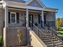 Brick house with covered porch and black railings at 444 19Th Avenue Nw Cir, Hickory, NC 28601