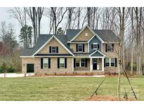 Two-story house with brick and siding exterior and attached garage at 9411 Stonebridge Way # 49, Mint Hill, NC 28227