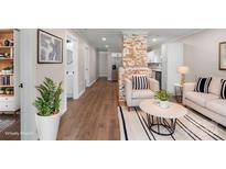 Bright living room with exposed brick, hardwood floors, and stylish furnishings at 305 N Watterson St, Kings Mountain, NC 28086