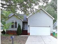Ranch home with gray siding, attached garage, and landscaping at 5115 Rosemede Dr, Charlotte, NC 28227