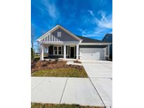 Newly built home with gray siding, white trim, and a two-car garage at 515 Tates Trl # 39, Cramerton, NC 28032