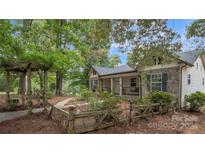 Charming home exterior with stone accents and arbor at 692 Hunters Ridge Rd, Taylorsville, NC 28681