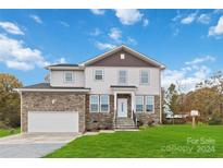 Two-story house with stone accents and a two-car garage at 1038 Heath Helms Rd, Monroe, NC 28110