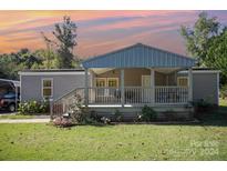 Mobile home with covered porch and landscaping at 1036 Lakeland Ave, Lincolnton, NC 28092