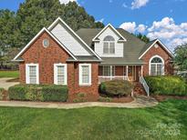 Brick home with landscaped yard at 2488 Birdie Ne Ln, Conover, NC 28613