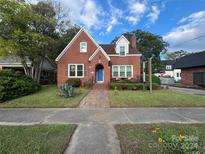 Brick home with a well-maintained lawn and inviting entryway at 109 N York St, Lancaster, SC 29720