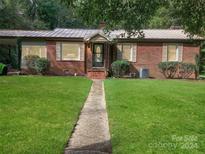 Brick ranch house with a spacious lawn and walkway at 305 N Milford Dr, Salisbury, NC 28144