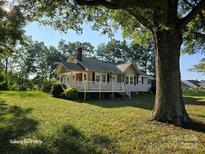 Ranch home exterior with large front yard and porch at 1176 Shearers Rd, Mooresville, NC 28115
