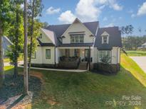 Two-story farmhouse style home with stone accents at 540 Kenway Loop, Mooresville, NC 28117