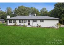 White ranch house with a landscaped lawn and a gray roof at 1001 E 22Nd St, Kannapolis, NC 28083