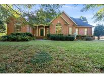 Two story brick home with landscaped lawn at 108 Cottonwood Dr, Mount Holly, NC 28120