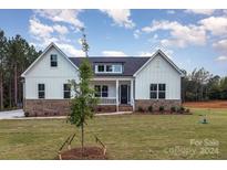 Charming farmhouse style home with brick and white siding at 1336 Sage Pine Cir # 21, Clover, SC 29710