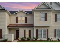 Two-story tan townhouse with brown shutters at 8333 Washoe Pine Ln, Charlotte, NC 28215