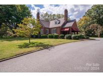Brick home with landscaped yard and driveway at 424 S College Ave, Newton, NC 28658