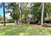 Two-story house with a large front yard and mature trees at 142 Scotland Dr, Mooresville, NC 28115