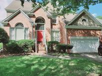 Two-story brick home with red door and attached garage at 4905 Benthaven Ln # 321, Charlotte, NC 28269