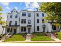 Modern three-story townhomes with white siding and gray accents at 647 District Ct # 15, Fort Mill, SC 29708